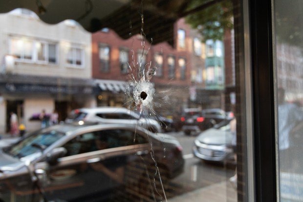 A bullet pierced the window of Modern Pastry, a go-to bakery in the North End, after a shooting this past summer. (Chris Van Buskirk/Boston Herald)