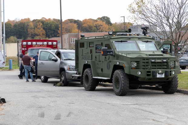 Portland first responder vehicles stage at Lewiston High School on Thursday, Oct. 26, 2023, where a large number of law enforcement were staging as the search for a suspect accused of a mass shooting.
