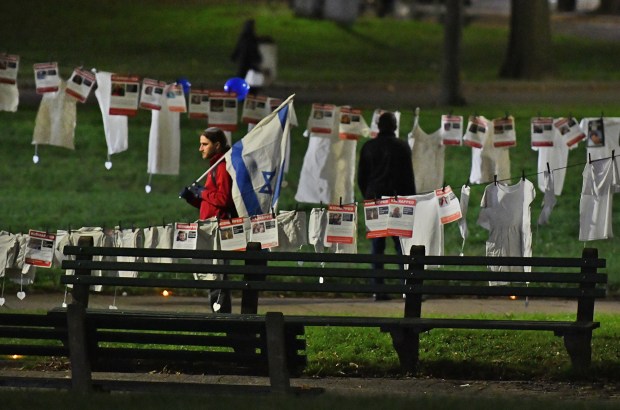 Boston, MA - October 23, 2023: People take in the display on the common showing victims of the assault on Israel. (Chris Christo/Boston Herald)