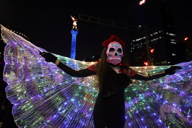 People dressed as "Catrinas" parade down Mexico City's iconic Reforma avenue during celebrations ahead of the Day of the Dead in Mexico, Sunday, Oct. 22, 2023. (AP Photo/Ginnette Riquelme)