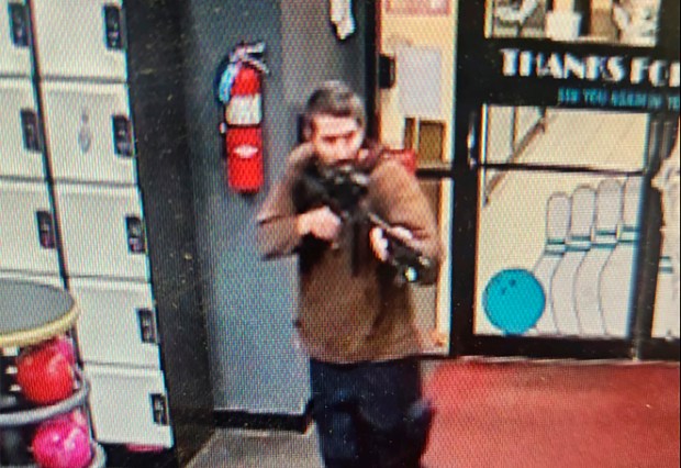 In this image taken from video released by the Androscoggin County Sheriff's Office, an unidentified gunman points a gun while entering Sparetime Recreation in Lewiston, Maine, on Wednesday, Oct. 25, 2023. Maine State Police ordered residents in the state's second-largest city to shelter in place Wednesday night as the suspect remains at large. (Androscoggin County Sheriff's Office via AP)