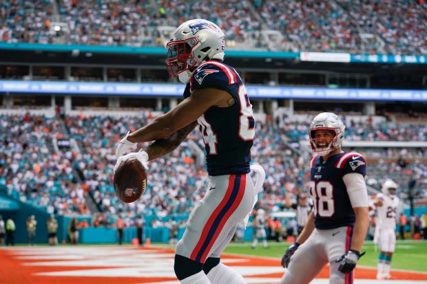 New England Patriots wide receiver Kendrick Bourne (84) celebrates after scoring a touchdown as tight end Mike Gesicki (88) reacts during the first half of an NFL football game against the Miami Dolphins, Sunday, Oct. 29, 2023, in Miami Gardens, Fla. (AP Photo/Lynne Sladky)