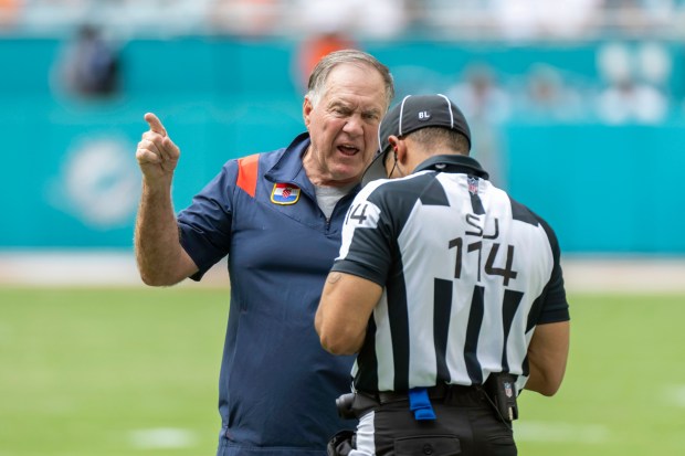 New England Patriots head coach Bill Belichick yells at NFL side judge Dominque Pender on the field during an NFL football game between the against the Miami Dolphins, Sunday, Oct. 29, 2023, in Miami Gardens, Fla. (AP Photo/Doug Murray)
