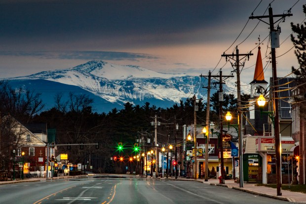 Mt. Washington looms in the distance over scenic North Conway, N.H., where most small shops and churches remain closed during the coronavirus pandemic, Sunday, April 26, 2020. (AP Photo/Robert F. Bukaty)