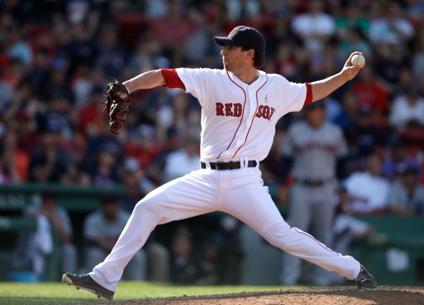 Boston Red Sox relief pitcher Craig Breslow winds up against the Cleveland Indians in the 10th inning of a June 15, 2014 game at Fenway Park in Boston. (AP Photo/Steven Senne)