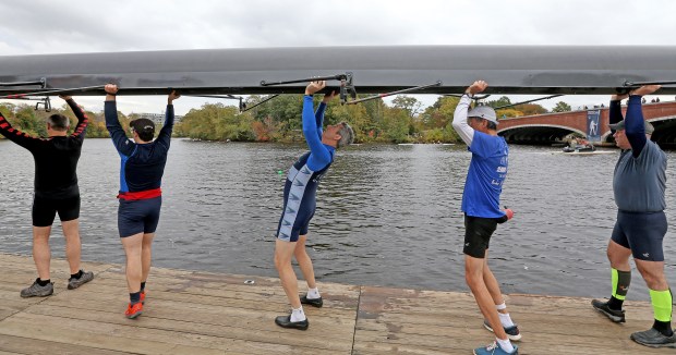Cambridge, MA - October 20: A 55 foot boat is lifted into position at the Cambridge Boat Club during the Head of the Charles. (Matt Stone/Boston Herald)