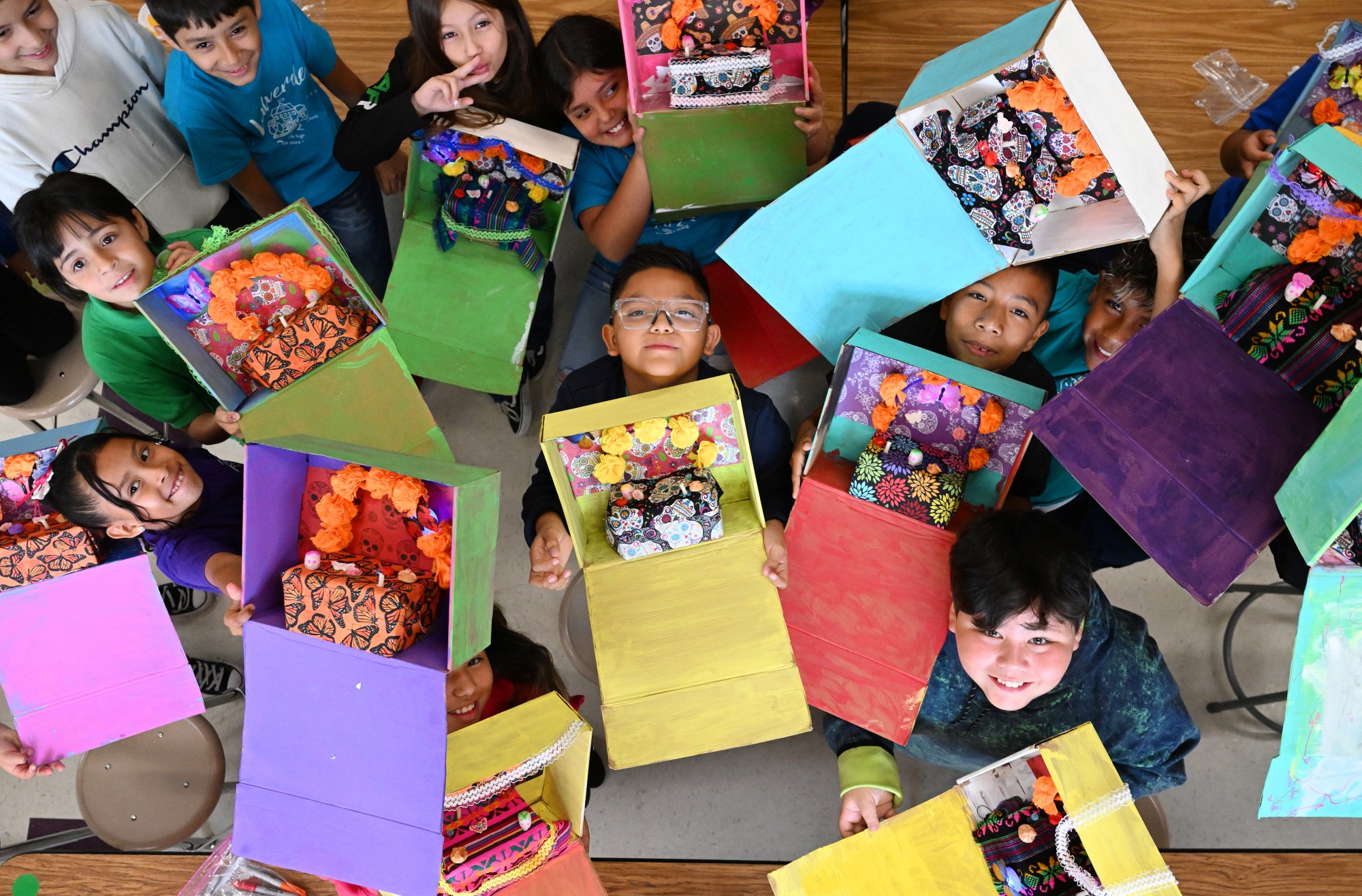 Fourth graders in Kristina Barboza's art class at Valverde Elementary School show off the Dia de los Muertos altars they are making on October 24, 2023, in Denver. (Photo by RJ Sangosti/The Denver Post)