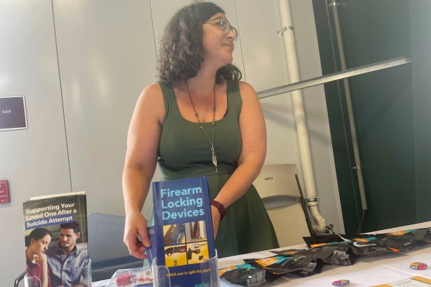 Jess Hegstrom, a public health worker for Lewis and Clark County in Montana, tries to start conversations about suicide risk at gun shows. "I'm not here to waggle my finger at you," she says. (Aaron Bolton/Montana Public Radio/KFF Health News/TNS)